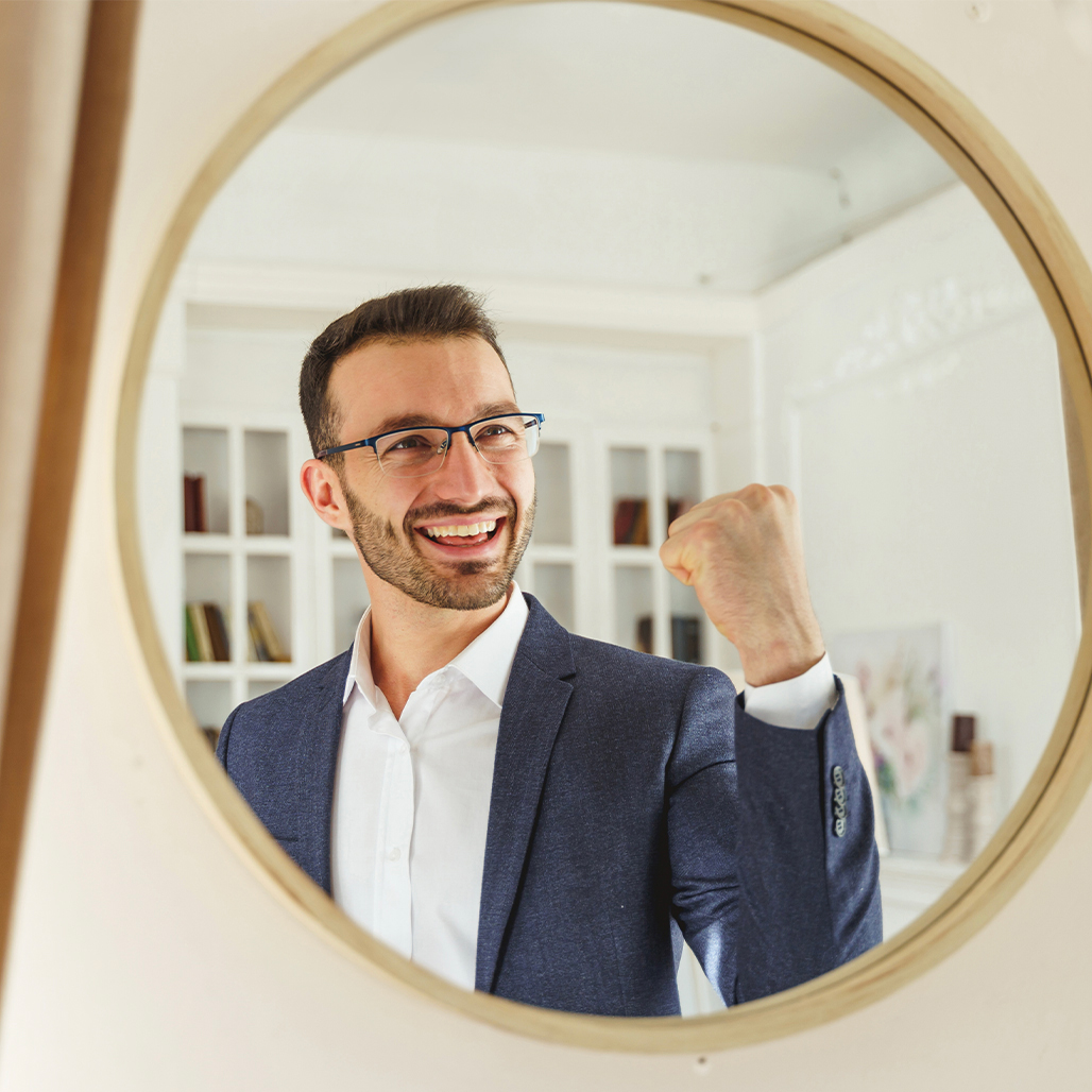 Kallen_Consulting_0002_waist-up-portrait-high-spirited-dark-haired-young-male-smiling-his-reflection-mirror